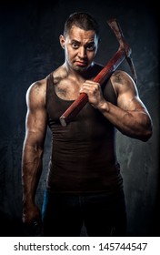 Muscular Man Holding Pickaxe