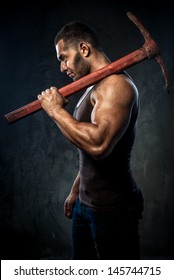 Muscular Man Holding Pickaxe