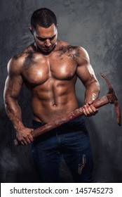 Muscular Man Holding Pickaxe