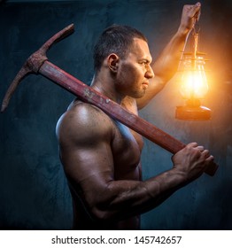 Muscular Man Holding Pickaxe And Oil Lamp