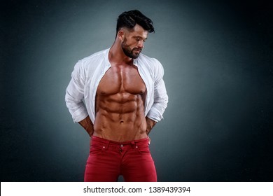 Muscular Man In Jeans Wearing Shirt Exposing His Muscular Build