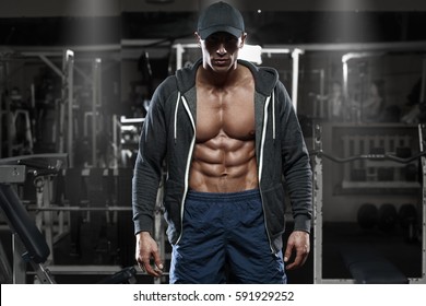 Muscular Man With Open Jacket Revealing Chest And Abs In Gym, Workout