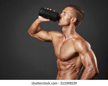Muscular Man With Protein Drink In Shaker