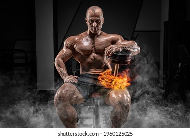 Muscular man sits on a bench with dumbbells burning. Bodybuilding and powerlifting concept. Mixed media