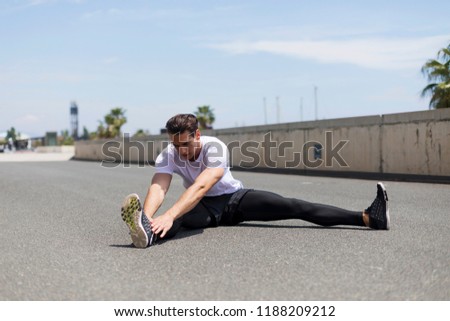 Similar – Athlete at the city park warming and stretching