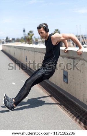 Similar – Strong Man Stretching Calf and Leaning on Wall