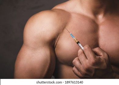 Muscular man with a syringe in his hand. Concept of a strength workout and anabolic steroids usage. - Powered by Shutterstock