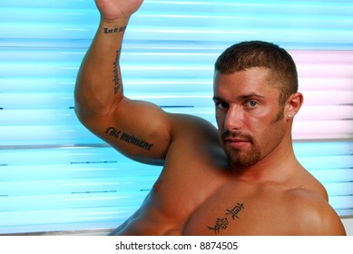 A Muscular Man In A Tanning Bed