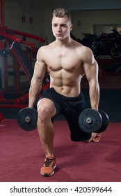 Muscular Man Topless Doing Lunges With Dumbbells In A Black Shorts In The Gym