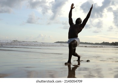 Muscular man, training arms and chest , athlete exercising, outdoors on beach , fit, fitness, healthy lifestyle concept