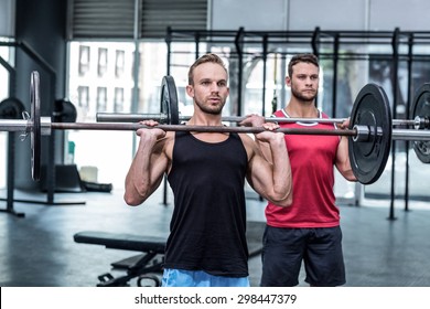 Muscular Men Lifting A Barbell At The Crossfit Gym