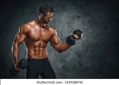 Muscular Men Lifting Weights. Studio Shot