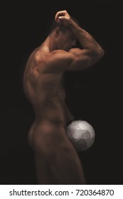 muscular naked man with soccer ball. Strong nude male body with veins