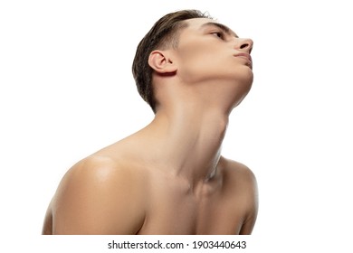 Muscular. Portrait of young man isolated on white studio background. Caucasian attractive male model. Concept of fashion and beauty, self-care, body and skin care. Handsome boy with well-kept skin.