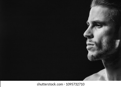 Muscular Sexy Model Sports Young Man On A Dark Background. Black And White Portrait Of Sporty Healthy Strong Brutal Muscle Guy With A Modern Trendy Hairstyle.