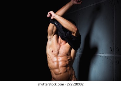 Muscular And Sexy Torso Of Young Man With Perfect Abs Taking Off His Shirt