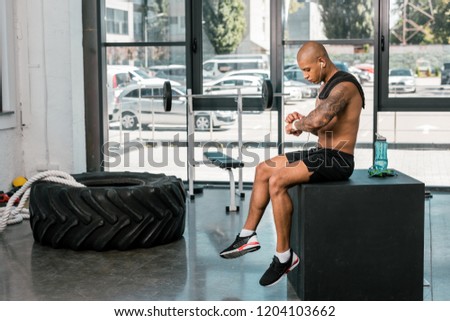 Similar – Image, Stock Photo Black shirtless man sitting with basketball