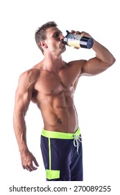 Muscular Shirtless Male Bodybuilder Holding Protein Shake Bottle, Drinking. Isolated On White