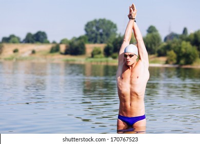 Muscular sportsman getting ready for a triathlon swim - Powered by Shutterstock