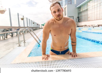 Muscular Swimmer Emerging From The Pool