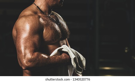 Muscular tired bodybuilder with white towel resting after training, with color imitating social network filter - Shutterstock ID 1340520776
