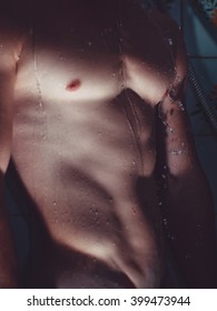 Muscular wet beautiful body(torso) of sexy man in the shower.
