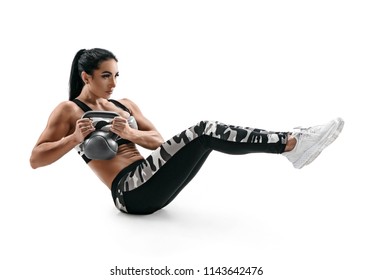 Muscular woman doing sit up exercise with kettlebell, abs. Photo of attractive latin woman in silhouette on white background. Strength and motivation - Powered by Shutterstock