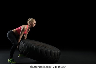 Muscular Woman Flip Big Tire 