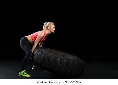 Muscular Woman Flip Big Tire 