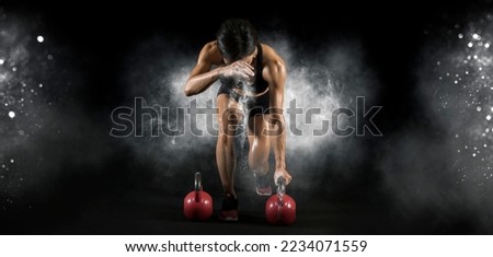 Muscular woman workout with kettlebell at gym