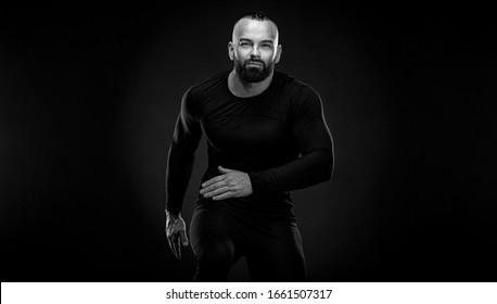 Muscular young fitness sports man athlete in compression garment. Workout in gym