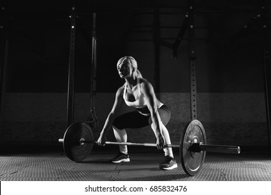 Muscular Young Fitness Woman Lifting A Weight Crossfit In The Gym. Fitness Woman Deadlift Barbell.