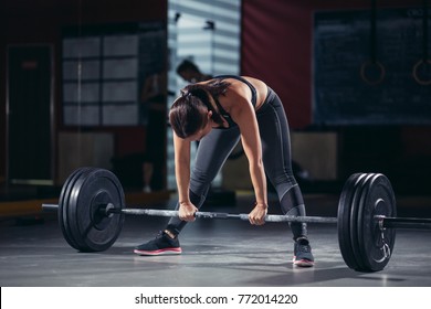 Muscular Young Fitness Woman Lifting A Weight Crossfit In The Gym. Fitness Woman Deadlift Barbell