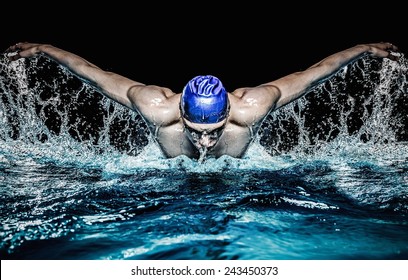 Muscular Young Man In Blue Cap In Swimming Pool