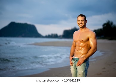 Muscular Young Man On Beach