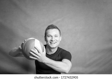 Muscular young man with volleyball ball, looking happy (black and white image) - Powered by Shutterstock