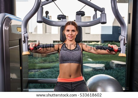 Similar – Image, Stock Photo One young athletic woman at crossfit training, exercising with trx suspension fitness straps over dark background, front view, looking at camera