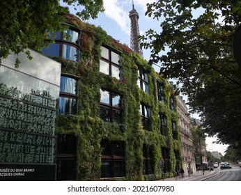 Musee Du Quai Branly - Jacques Chirac, PARIS-AUGUST 8, 2021: The Museum And The Eiffel Tower Under The Blue Sky And White Clouds