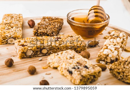 Museli, cereal, granola protein energy bars and honey