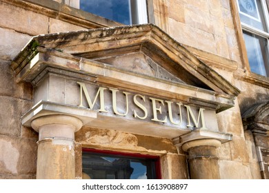 The Museum Sign Above The Entrance Door In Neo Classical Architectural Style