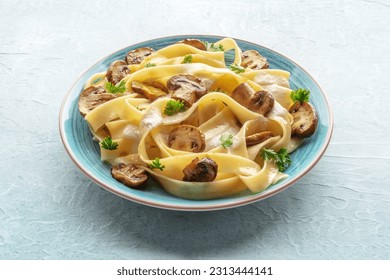 Mushroom pasta, pappardelle with creamy sauce and parsley, on a stone background. Italian dinner - Powered by Shutterstock