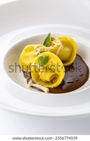 Mushroom ravioli with black sauce 