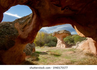 Mushroom Rock through cave window in Cappadocia, Turkey
