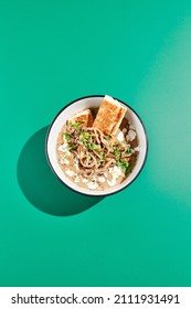 Mushroom Soup With Bread On Green Background. Autumn Soup In Minimal Style. Creamy Mushroom Soup In Bowl In Modern Concept. Colour Background And Hard Shadow In Food Menu