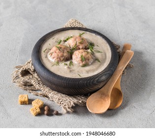 Mushroom Soup Puree With Meatballs, Dill And Croutons In A Wooden Bowl On A Linen Napkin On A Light Gray Background In Rustic Style