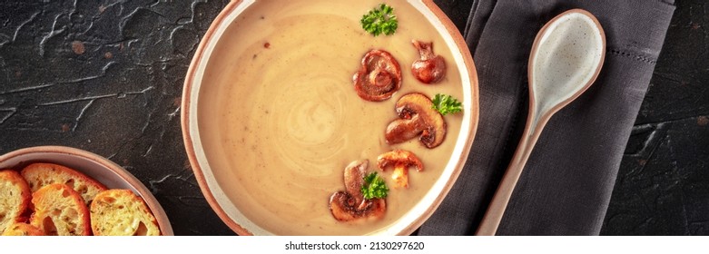 Mushroom Soup In A Rustic Bowl, An Overhead Panoramic Shot On A Black Slate Background