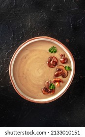 Mushroom Soup In A Rustic Bowl, Overhead Shot On A Black Slate Background