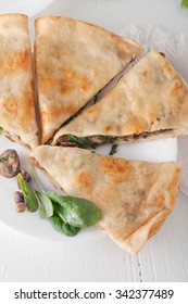 Mushroom Spinach Quesadilla Cut Into Pieces And Arranged On White Plate, Overhead Shot, Vertical Image