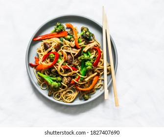 Mushrooms, Broccoli, Sweet Peppers, Teriyaki Stir Fry Sauce With Noodles On A Light Background, Top View