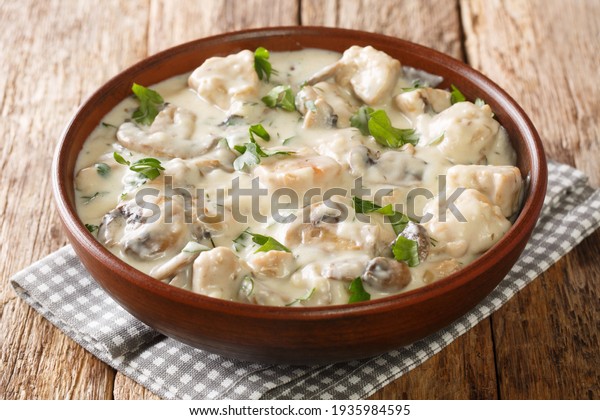 Mushrooms and Chicken in White Sauce closeup\
in the plate on the table.\
Horizontal\
